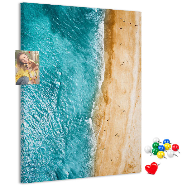 Memo cork board A beach with waves and people walking around