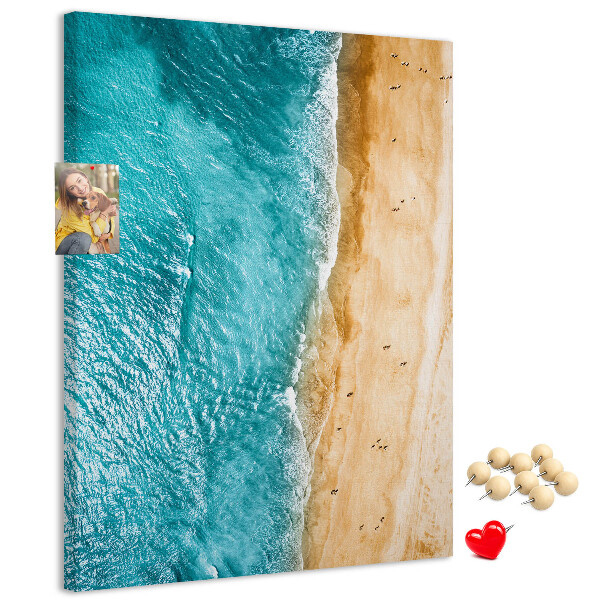 Memo cork board A beach with waves and people walking around