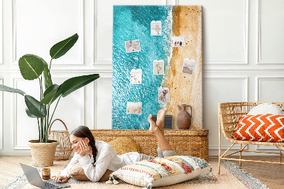 Memo cork board A beach with waves and people walking around