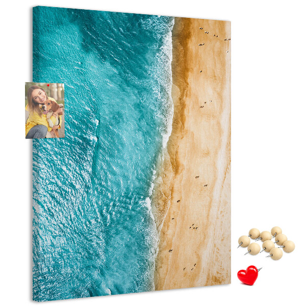 Memo cork board A beach with waves and people walking around