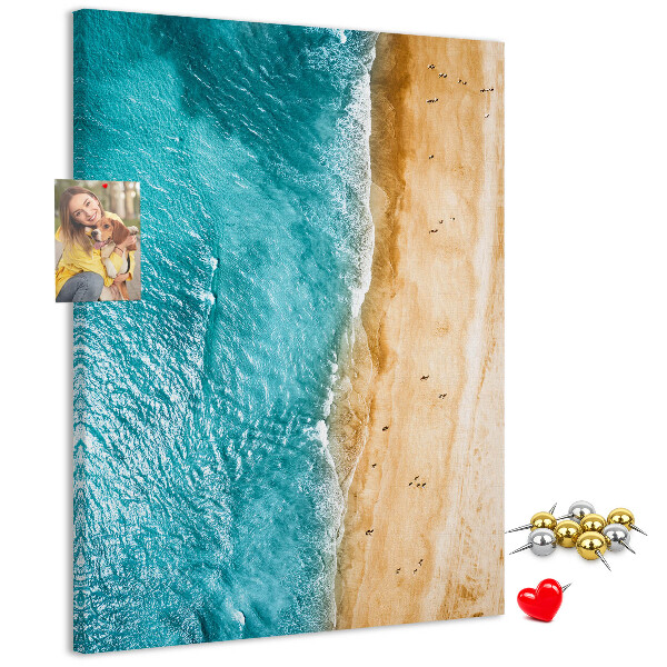 Memo cork board A beach with waves and people walking around