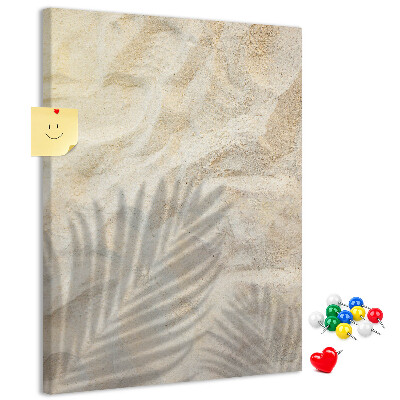 Pin board Desert sand with the delicate shadow of a leaf