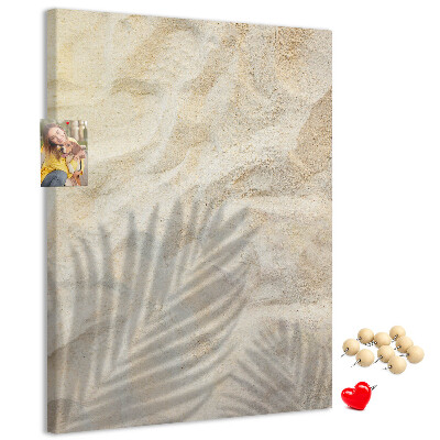 Pin board Desert sand with the delicate shadow of a leaf