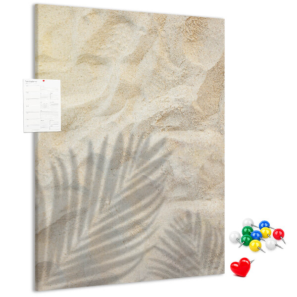 Pin board Desert sand with the delicate shadow of a leaf