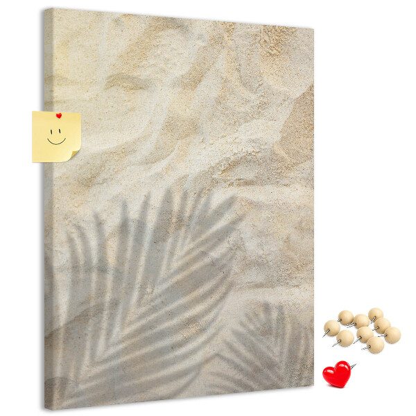 Pin board Desert sand with the delicate shadow of a leaf