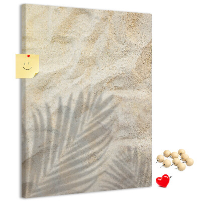 Pin board Desert sand with the delicate shadow of a leaf