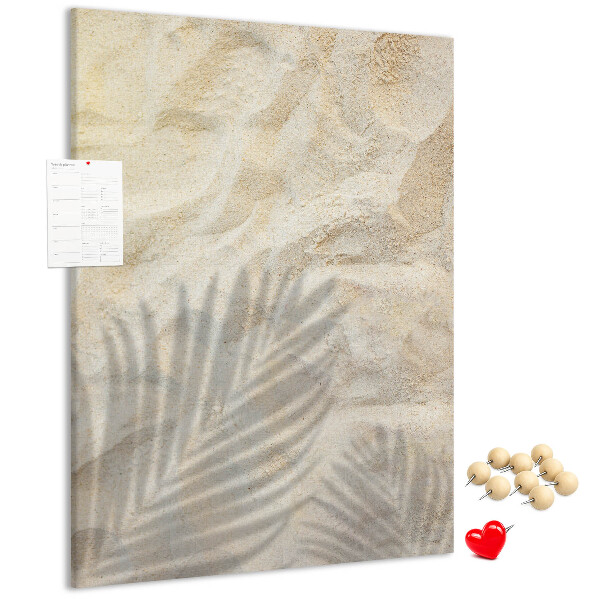 Pin board Desert sand with the delicate shadow of a leaf
