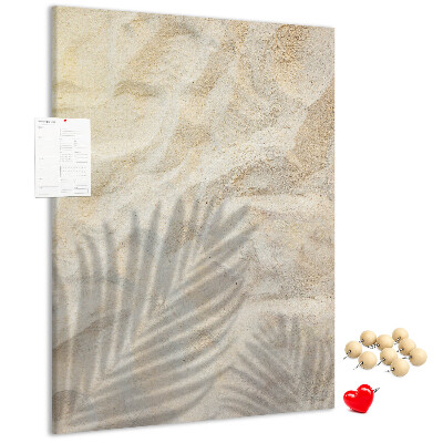 Pin board Desert sand with the delicate shadow of a leaf