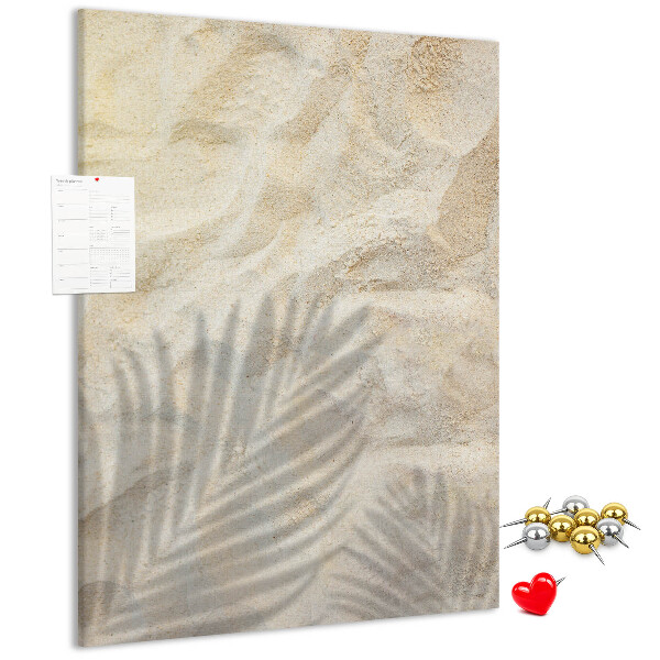 Pin board Desert sand with the delicate shadow of a leaf