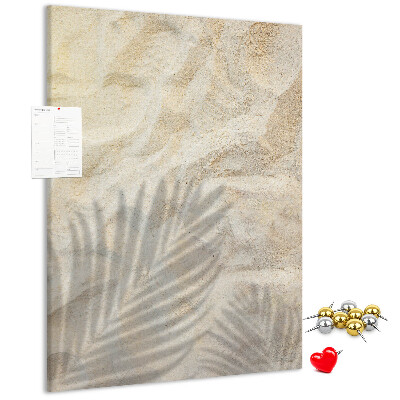Pin board Desert sand with the delicate shadow of a leaf