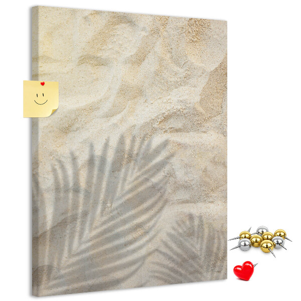 Pin board Desert sand with the delicate shadow of a leaf