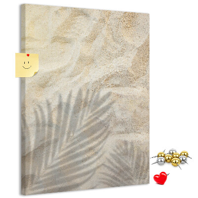 Pin board Desert sand with the delicate shadow of a leaf