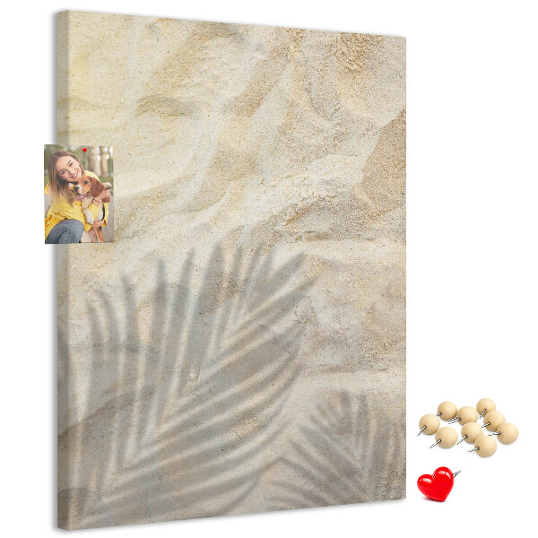 Pin board Desert sand with the delicate shadow of a leaf