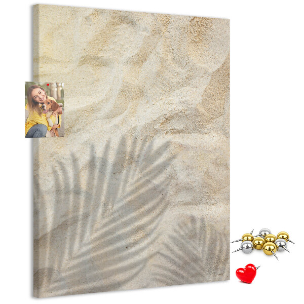 Pin board Desert sand with the delicate shadow of a leaf