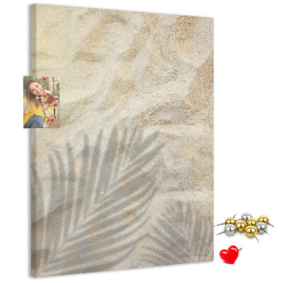 Pin board Desert sand with the delicate shadow of a leaf