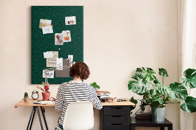 Cork notice board Background with leaves on a dark green background