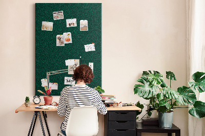 Cork notice board Background with leaves on a dark green background