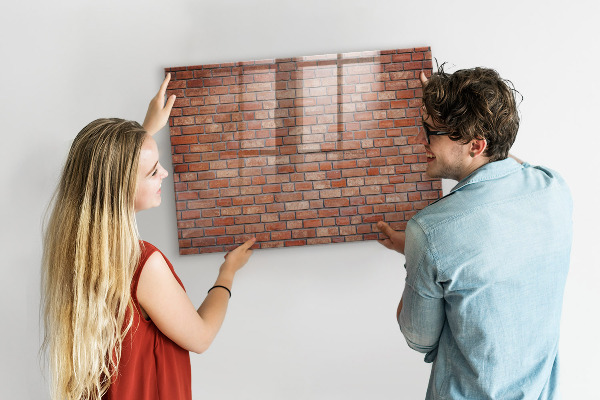Dry erase board magnetic A note board on a brick wall
