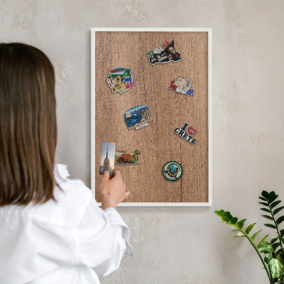 Magnetic board for travel magnets in a white frame Wood texture