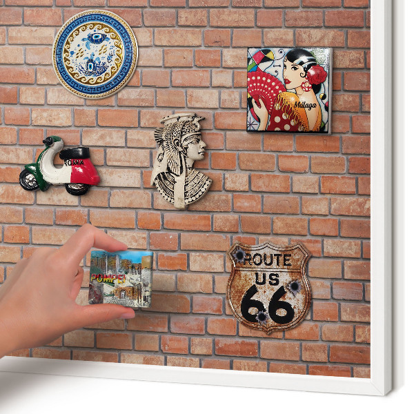 Magnetic board for travel magnets in a white frame Brick wall