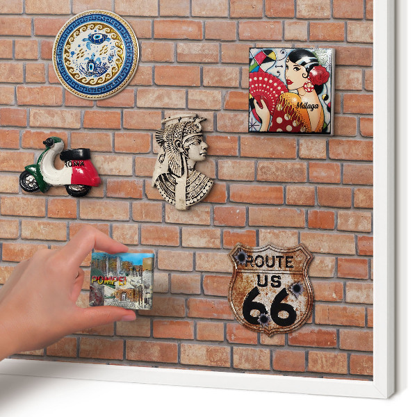 Magnetic board for travel magnets in a white frame Brick wall