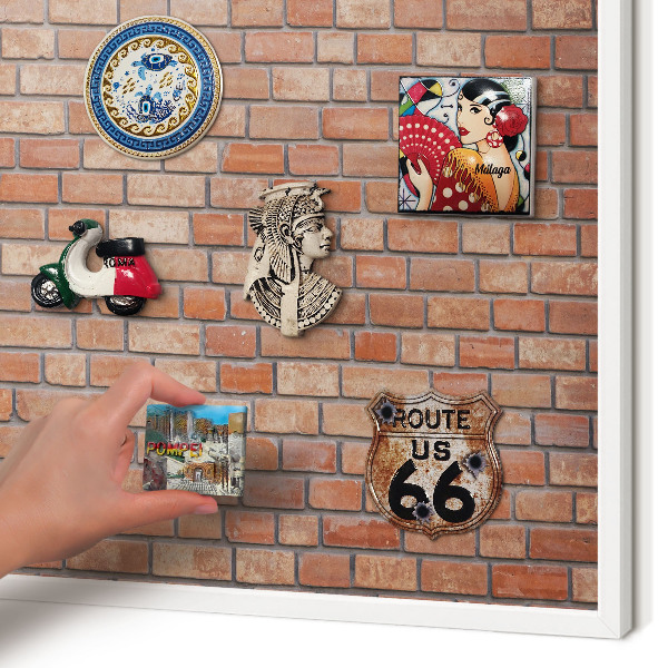 Magnetic board for travel magnets in a white frame Brick wall