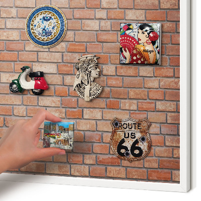 Magnetic board for travel magnets in a white frame Brick wall