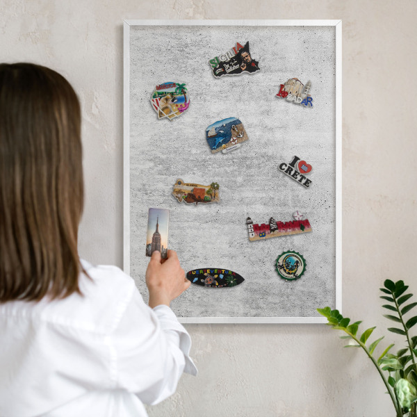 Magnetic board for travel magnets in a white frame Gray texture