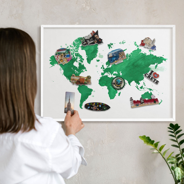 Magnetic board for travel magnets in a white frame Green map