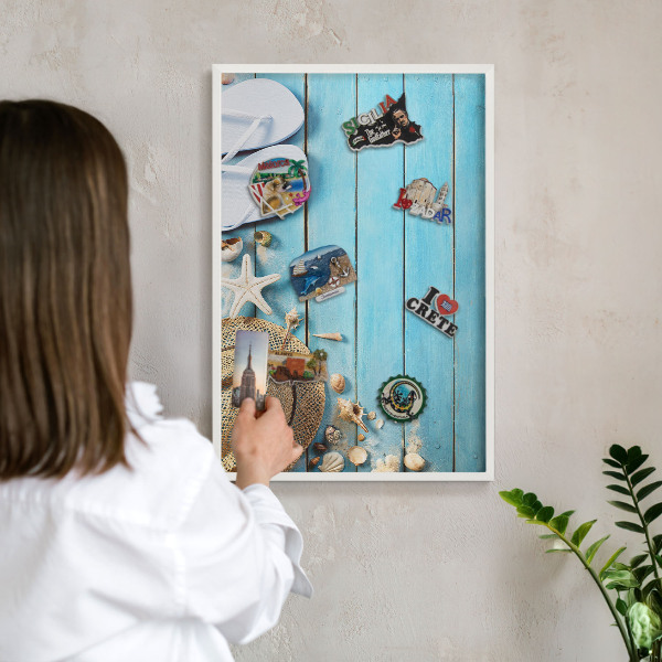 Magnetic board for travel magnets in a white frame Holiday atmosphere