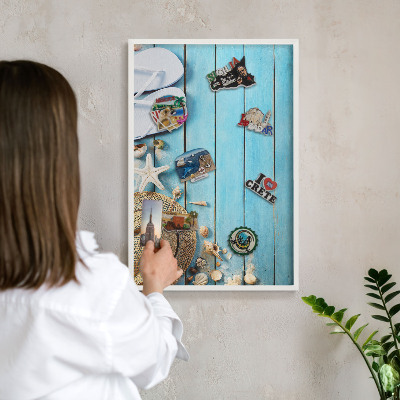 Magnetic board for travel magnets in a white frame Holiday atmosphere