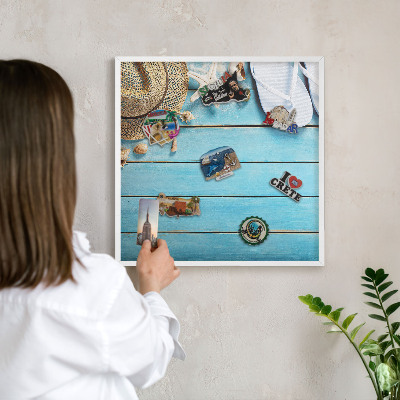 Magnetic board for travel magnets in a white frame Holiday atmosphere
