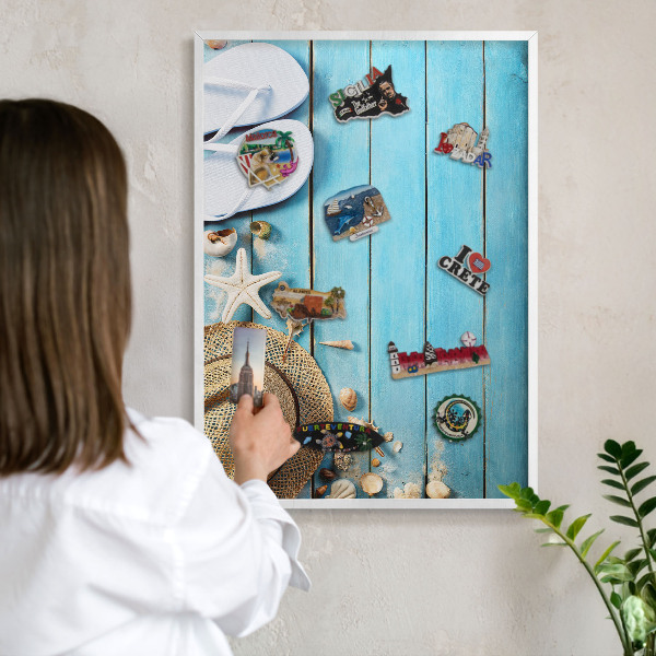 Magnetic board for travel magnets in a white frame Holiday atmosphere
