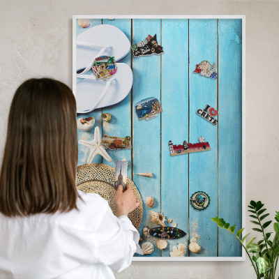 Magnetic board for travel magnets in a white frame Holiday atmosphere