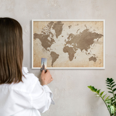 Magnetic board for travel magnets in a white frame World map