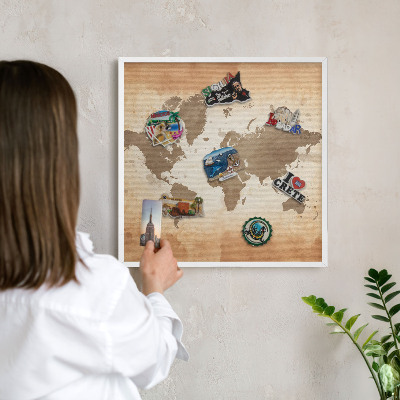 Magnetic board for travel magnets in a white frame World map