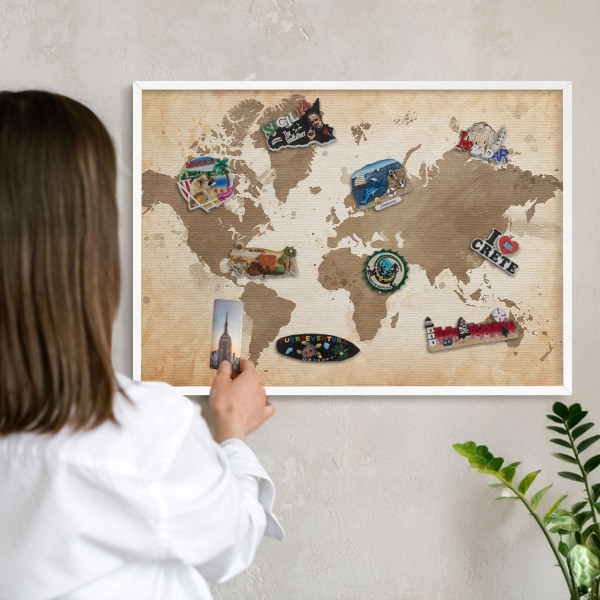 Magnetic board for travel magnets in a white frame World map