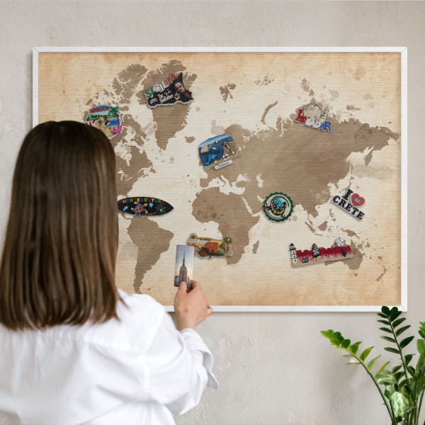 Magnetic board for travel magnets in a white frame World map