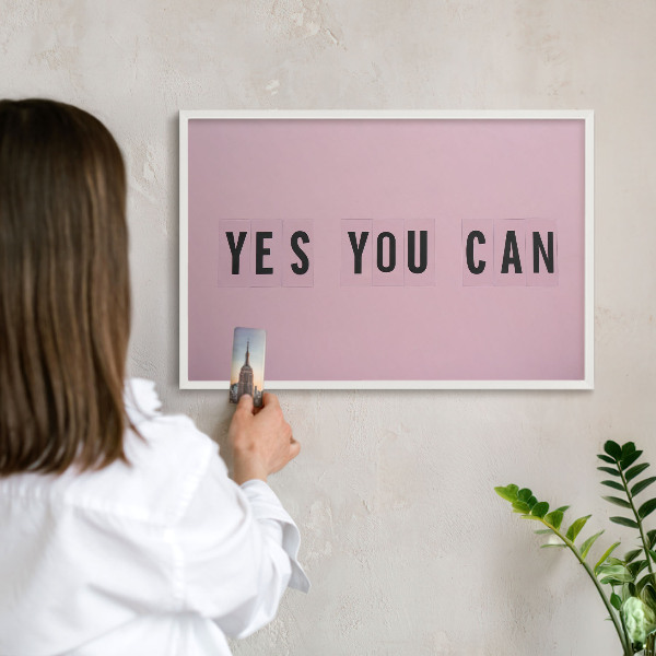 Magnetic board for travel magnets in a white frame Motivation every day