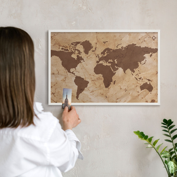 Magnetic board for travel magnets in a white frame World map