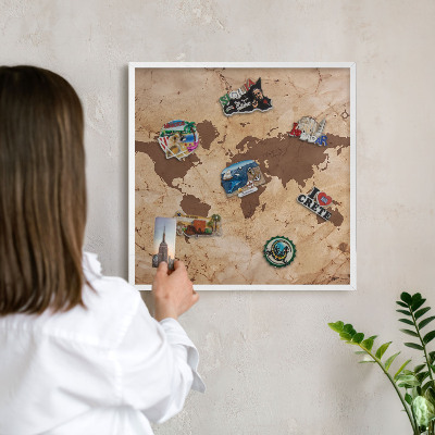 Magnetic board for travel magnets in a white frame World map