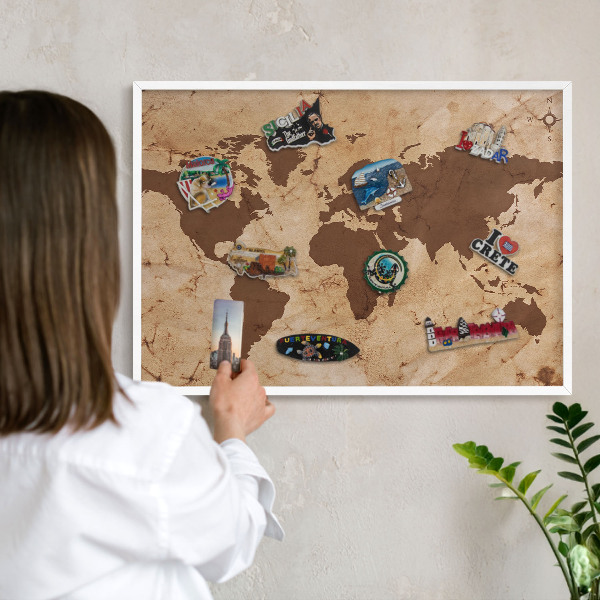 Magnetic board for travel magnets in a white frame World map