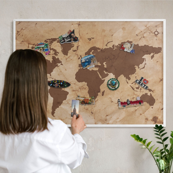 Magnetic board for travel magnets in a white frame World map