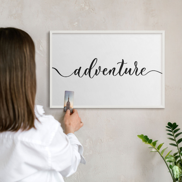 Decorative magnet board with a white frame Adventure written