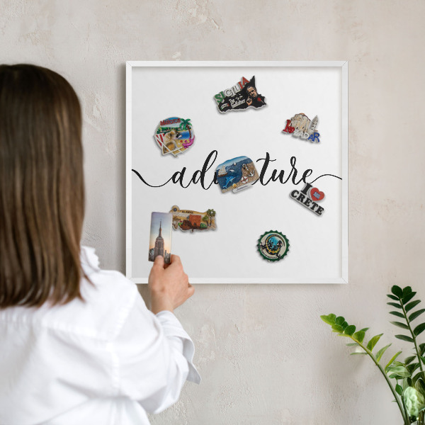 Decorative magnet board with a white frame Adventure written