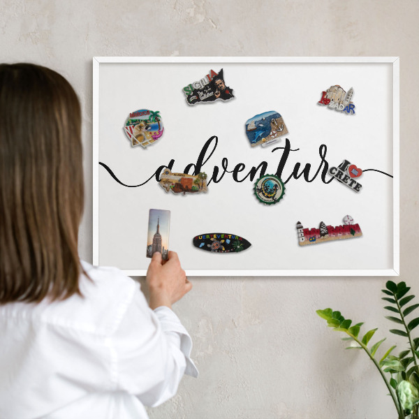 Decorative magnet board with a white frame Adventure written