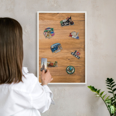 Magnetic board for travel magnets in a white frame Wooden texture