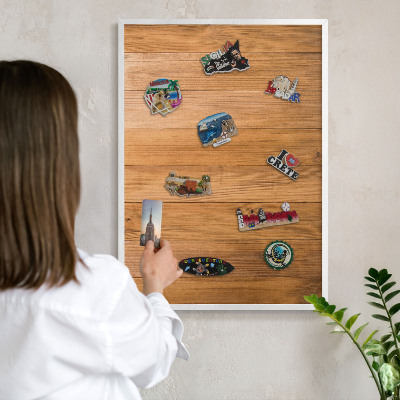 Magnetic board for travel magnets in a white frame Wooden texture