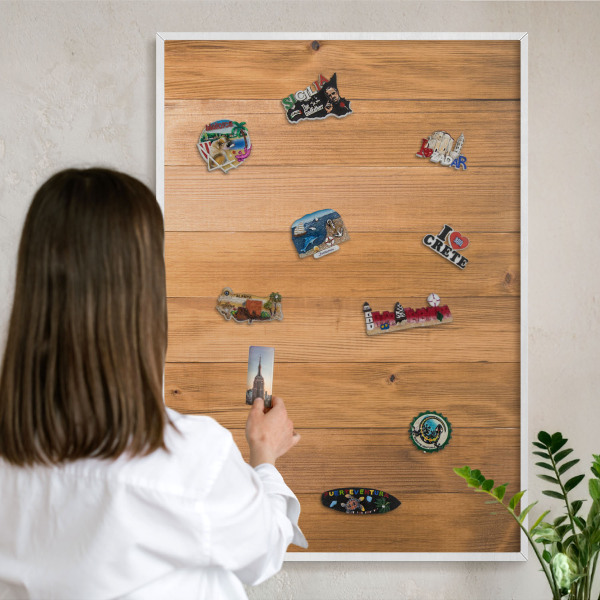 Magnetic board for travel magnets in a white frame Wooden texture