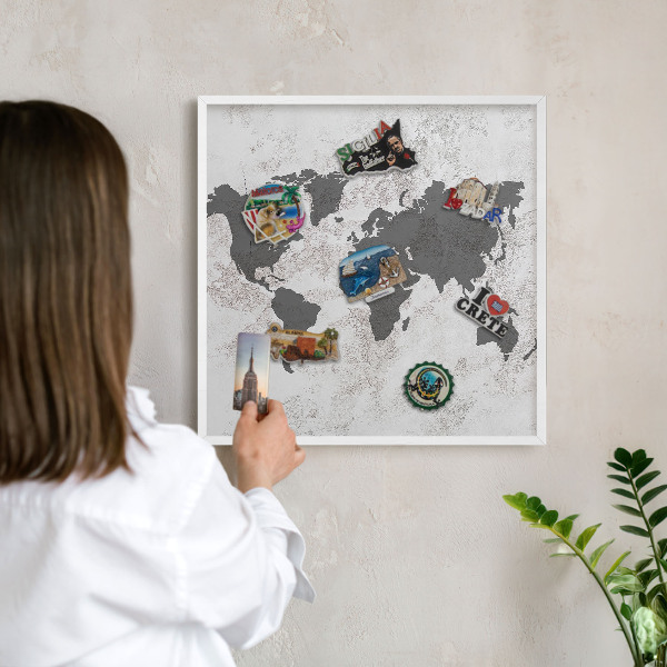 Magnetic board for travel magnets in a white frame World map